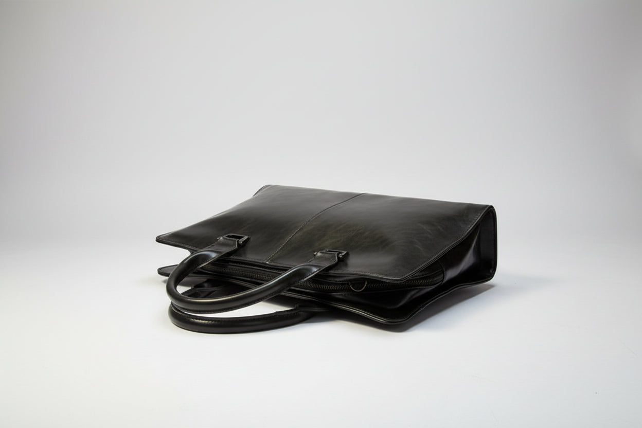 Black leather handbag on a white background