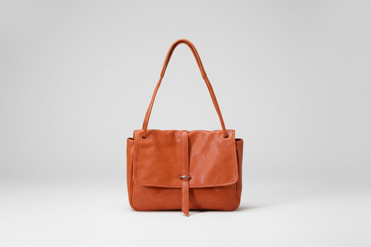 Brown leather handbag on a white background