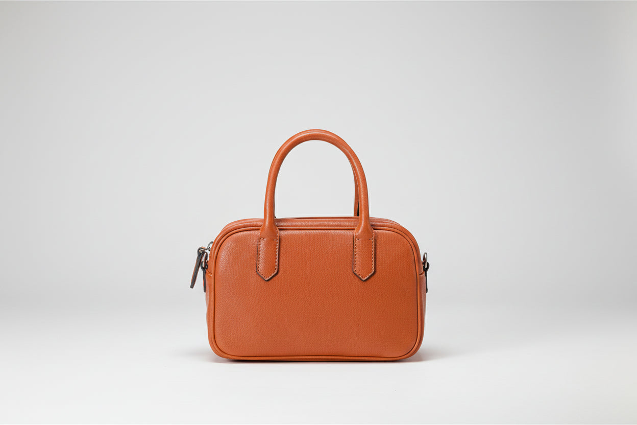 Brown leather handbag on a white background