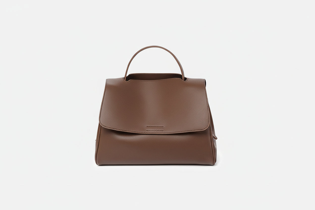 Brown leather handbag on a white background