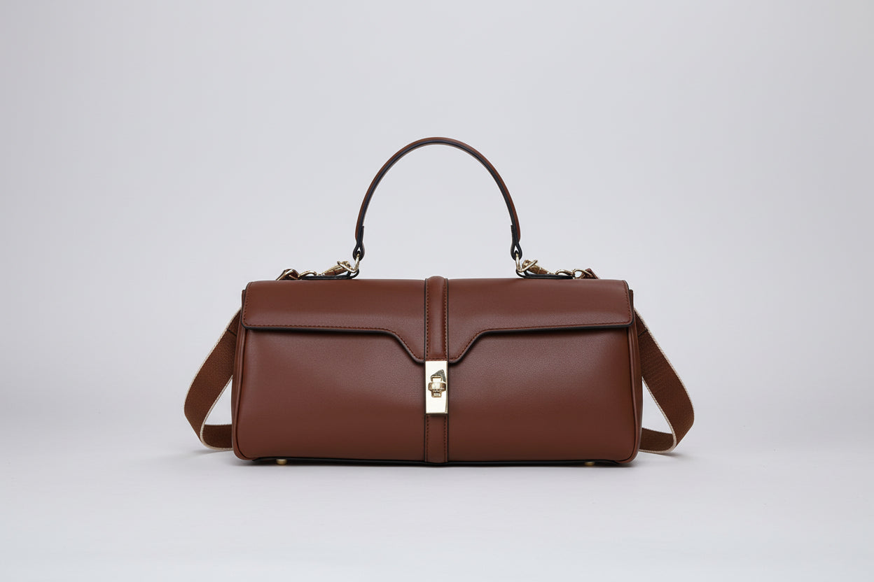 Brown leather handbag with a silver clasp on a white background