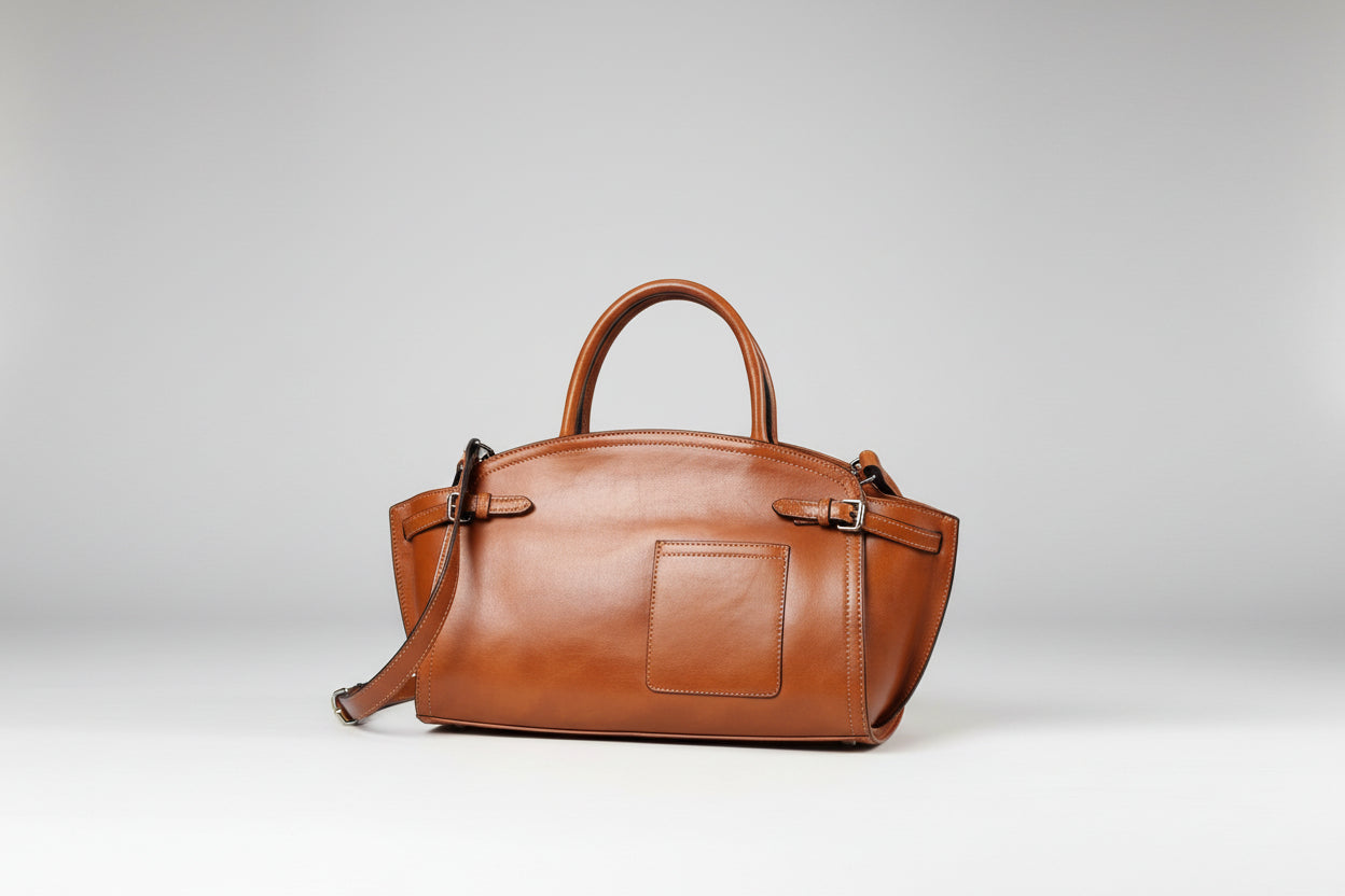 Brown leather handbag on a white background