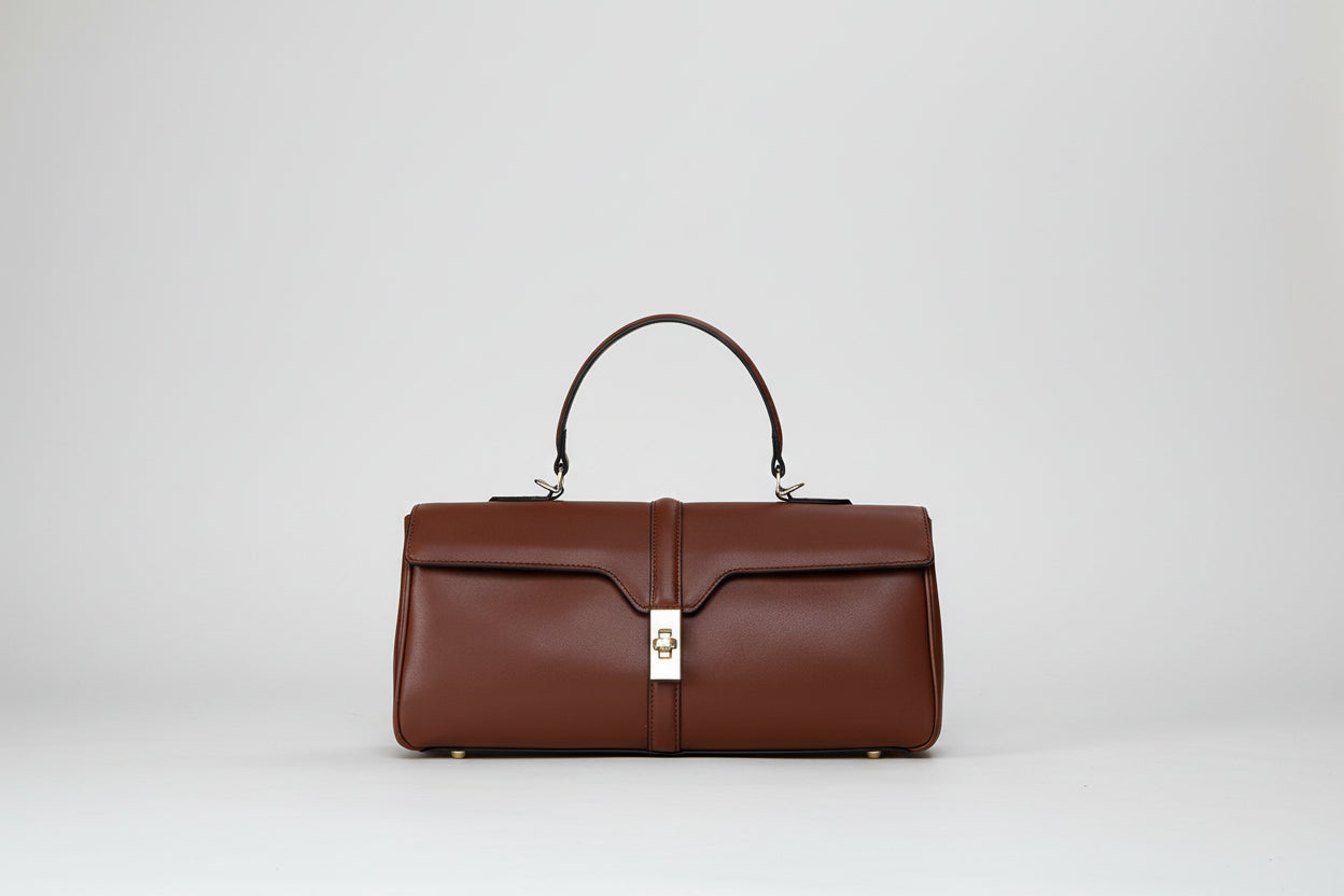 Brown handbag with a gold clasp on a white background