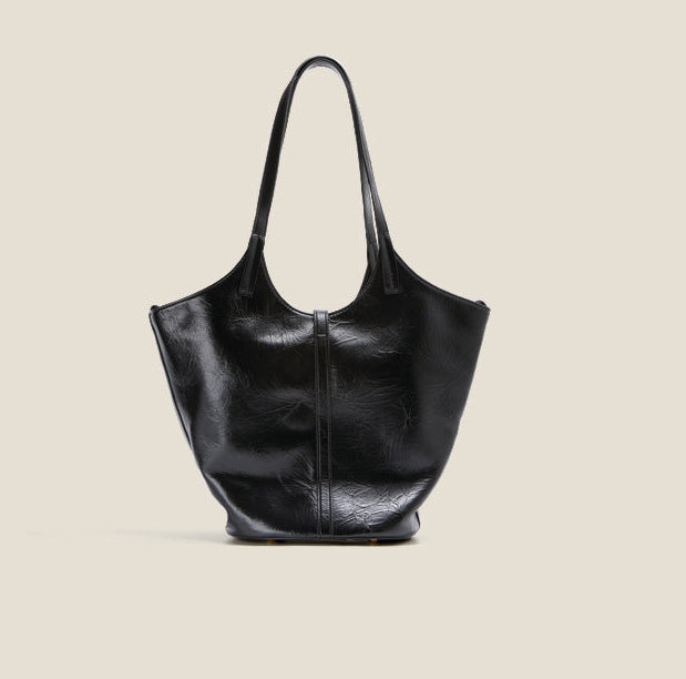Black leather handbag on a beige background