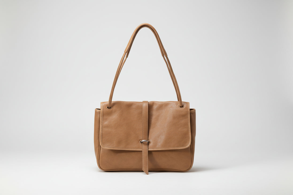 Brown leather handbag on a white background
