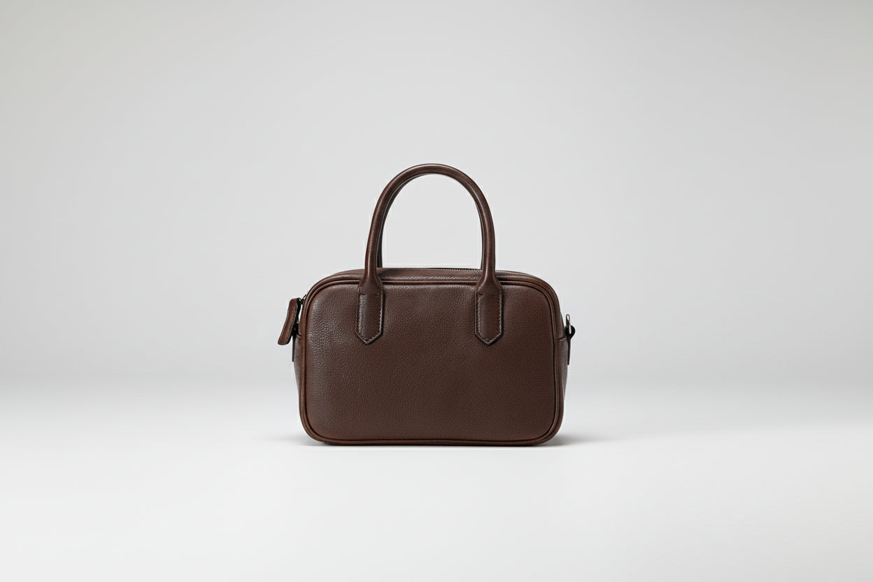 Brown leather handbag on a white background
